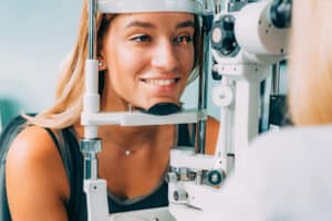 Young woman smiles during eye exam in Santa Rosa, CA