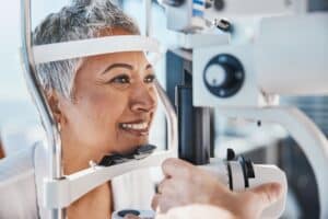 Mature woman at the eye doctor’s getting an eye exam.